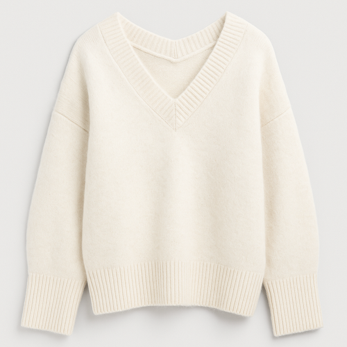 Knit v-neck sweater with ribbed cuffs and relaxed fit, styled in a soft cozy texture