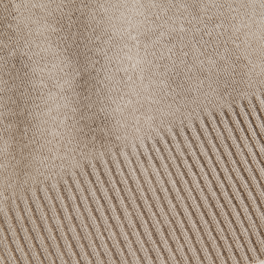 Knit button sweater with relaxed fit and partial placket, styled in a soft neutral tone